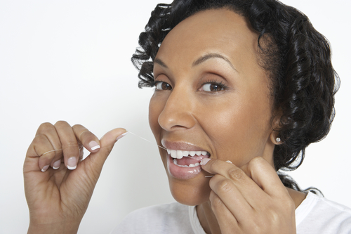 Woman flossing teeth
